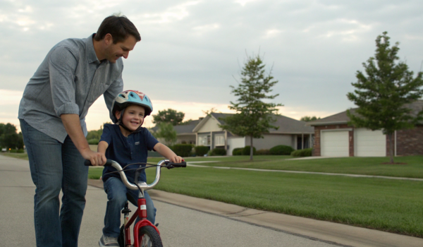 a-father-helping-his-child-ride-a-bicycle-for-the-